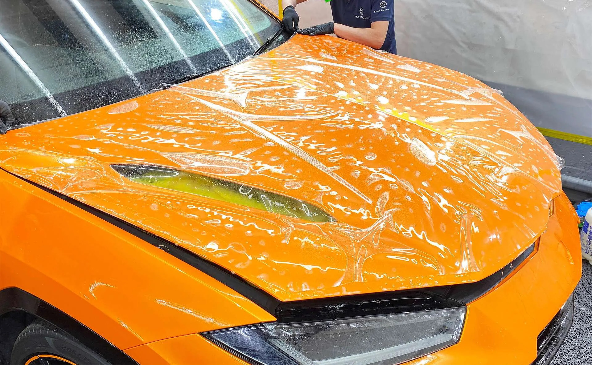 STEK DYNOshield paint protection film (PPF) being applied to a car bonnet at Hypercare Automotive in Leicester